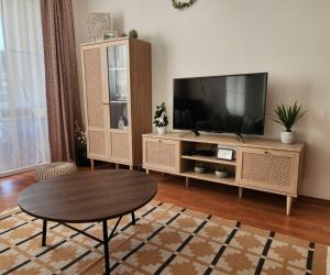 a living room with a tv and a coffee table at Apartmán v centre Donovaly s garážou in Donovaly