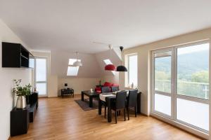 a living room with a table and a dining room at River Park Oasis apartment in Sandanski