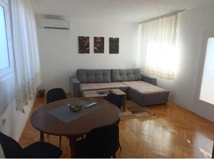 a living room with a table and a couch at MiYo STAY in Žitkovac