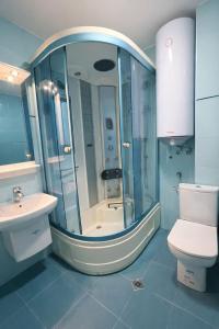 a bathroom with a shower and a toilet and a sink at River Park Oasis apartment in Sandanski