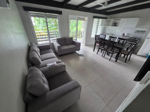 a large living room with a couch and a kitchen at Savusavu Terraces - Unit 3 in Savusavu