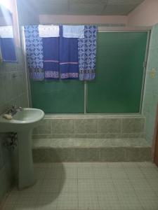 a bathroom with a sink and a shower and a sink at Affordable Spacious Studio Apartment in Nueva California