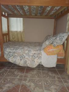 a small bed in a room with a bed sqor at Affordable Spacious Studio Apartment in Nueva California