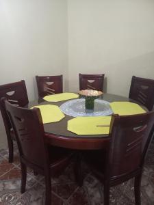 a dining room table with chairs and a bowl on it at Affordable Spacious Studio Apartment in Nueva California