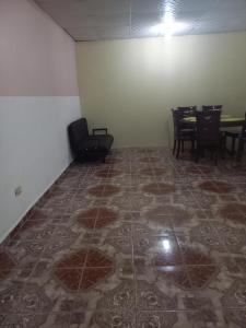 a room with a table and chairs and a tile floor at Affordable Spacious Studio Apartment in Nueva California +6 photos