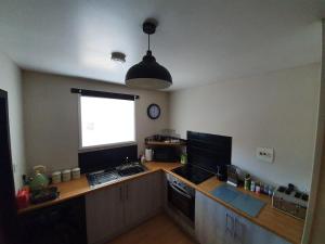 a kitchen with a counter with a sink and a window at Spacious 2 Double Bedroom House Wick Harbour in Wick