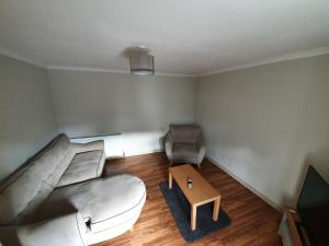 a living room with a couch and a coffee table at Spacious 2 Double Bedroom House Wick Harbour in Wick