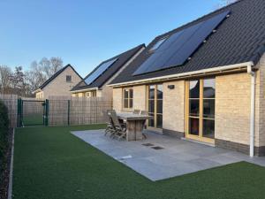 a house with solar panels on the roof at Vitamin Sea in Oostduinkerke