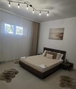 a bedroom with a large bed with lights on it at KEFI House in Pondolívadhon