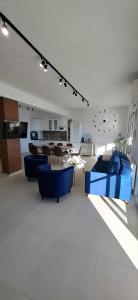 a living room with blue furniture and a table at KEFI House in Pondolívadhon