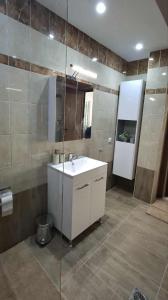 a bathroom with a sink and a mirror at KEFI House in Pondolívadhon +16 photos
