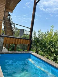 a swimming pool in front of a house at Garden House in Yerevan