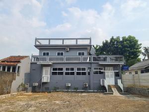 a gray house with a balcony on top of it at JS Sentul City in Cibitung