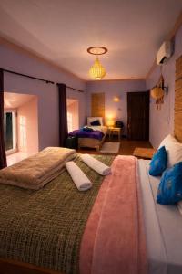 a large bedroom with two beds and a room with a bed at DAR DANI café restaurant in Boumalne Dades
