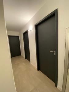 a hallway with three doors in a building at Pepy & Delmis in Chens-sur-Léman