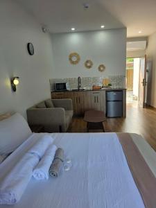 a bedroom with a white bed and a kitchen at MSResort Panglao in Looc