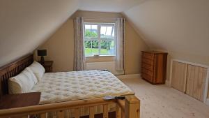 a bedroom with a large bed and a window at lakeview Guesthouse Virginia in Lisgrea
