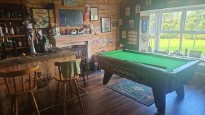 a billiard room with a pool table and a bar at lakeview Guesthouse Virginia in Lisgrea