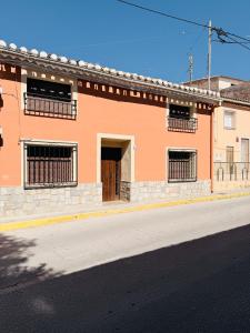 an orange building on the side of a street at Casa Luisa Archivel in Archivel