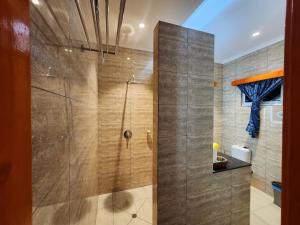 a shower with a glass door in a bathroom at Villa Admiral in Praslin +100 photos