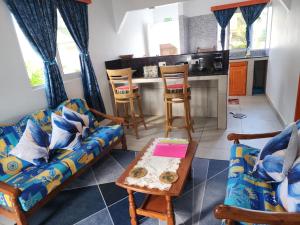 a living room with a couch and a table at Villa Admiral in Praslin