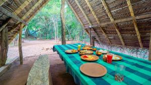 a blue table with plates of food on it at Sigiri Jungle Camping in Sigiriya