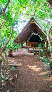 a picnic shelter in the middle of a forest at Sigiri Jungle Camping in Sigiriya