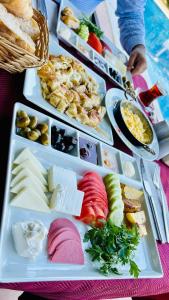 a table with several trays of different types of food at jasmine otel in Kemer