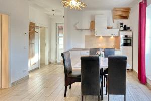 a kitchen and dining room with a table and chairs at Luftschloss Baum 6 in Burg