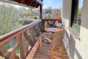 a porch with a table and chairs on a balcony at Luftschloss Baum 6 in Burg