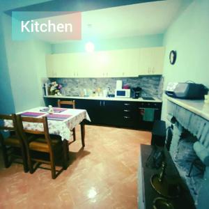 a kitchen with a table and chairs and a table and a counter at Kroi'Pistolve in Krujë +24 photos