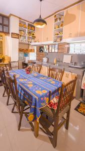a kitchen with a table with a blue table cloth at 18 Camella in Baguio