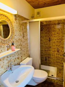 a bathroom with a sink and a toilet and a mirror at Frühstückspension Waldeck in Mayrhofen