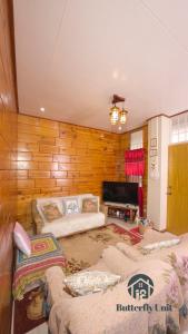 a living room with a couch and a tv at 18 Camella in Baguio