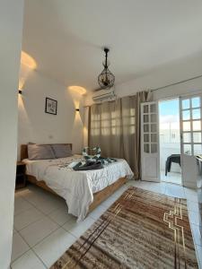 a bedroom with a large bed and a window at Antika Hotel in Dahab