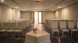 a room with rows of chairs and a box on a table at AG Hotel & Spa Marrakech in Marrakesh +42 photos