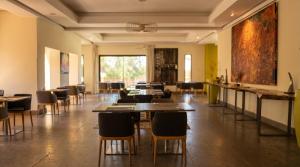 a room with tables and chairs and a large window at AG Hotel & Spa Marrakech in Marrakesh