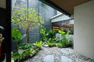 a garden in the side of a building with plants at Leston Hotel in Bangkok