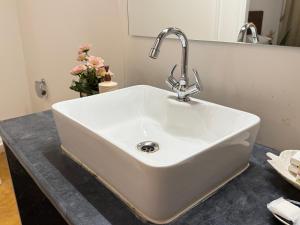 a white sink in a bathroom with a mirror at Anexx Goa in Vagator +43 photos