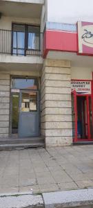 a building with a blue door on the side of it at Студио in Shumen