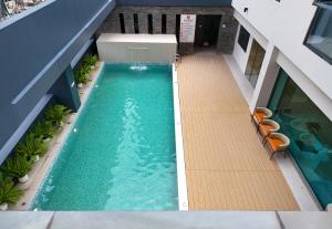 an overhead view of a swimming pool in a building at Leston Hotel in Bangkok