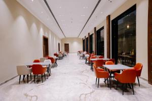 a row of tables and chairs in a room at Pride Premier Alwar - Sariska in Alwar