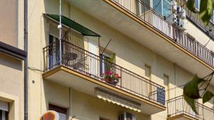 a building with two balconies with flowers on it at MASA 2Rooms in Piazza Armerina