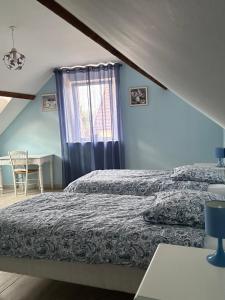 a bedroom with two beds and a window at La Grange de Flavigny in Flavigny +13 photos