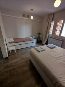 a bedroom with a bed and a bench in it at Cozy rural apartment in Calaceite