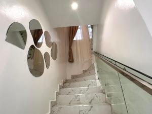 a staircase with two mirrors on the wall at Tranquil Residences - Orchid, Lekki in Lekki