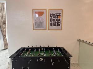 a pool table in a room with two pictures on the wall at Tranquil Residences - Orchid, Lekki in Lekki +16 photos