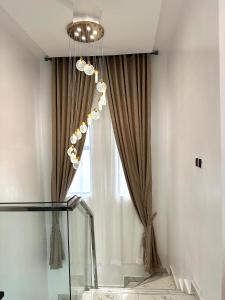 a chandelier in a room with a window at Tranquil Residences - Orchid, Lekki in Lekki