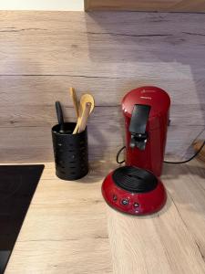 a red blender sitting on top of a counter at Studio Douillet in Mâcon