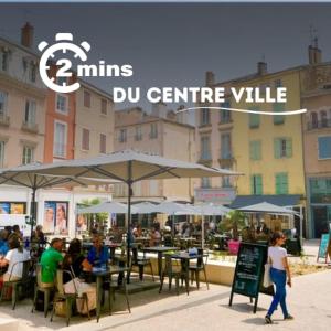 a group of people sitting at tables with umbrellas at Studio Douillet in Mâcon